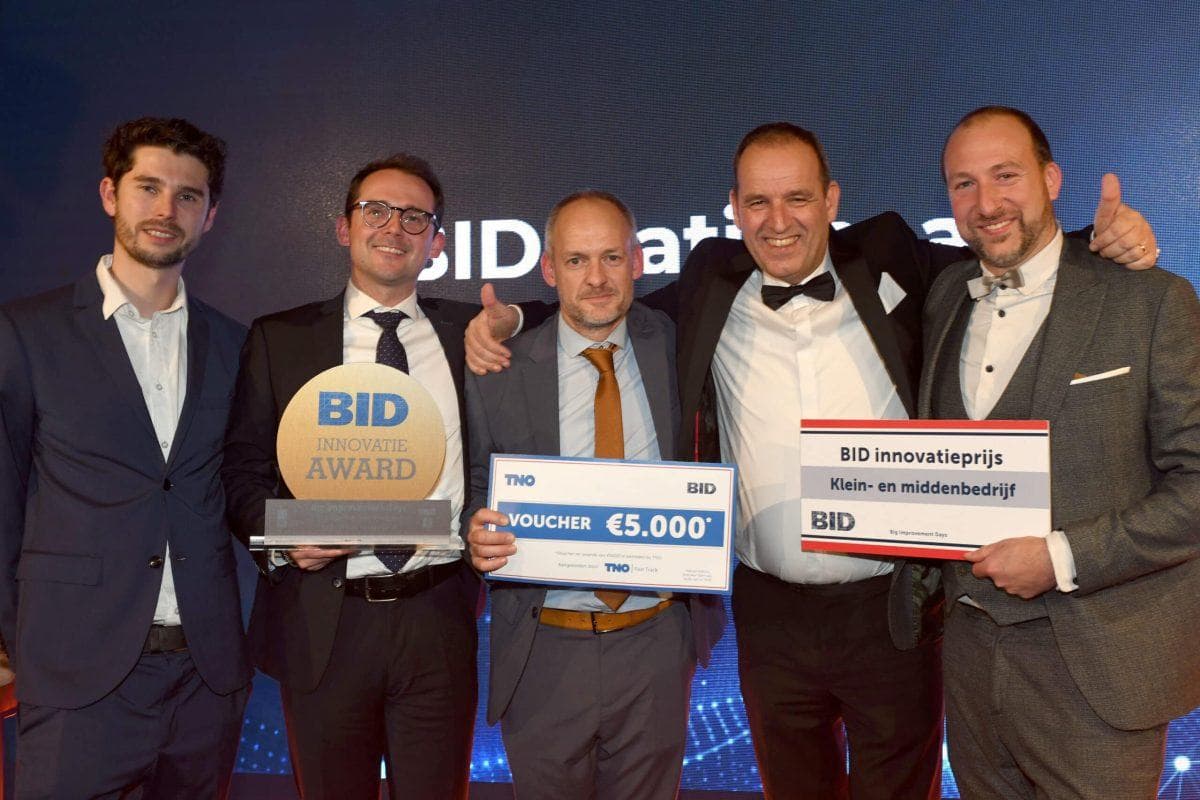 Winners of the BID Innovation Award on stage with their trophy.